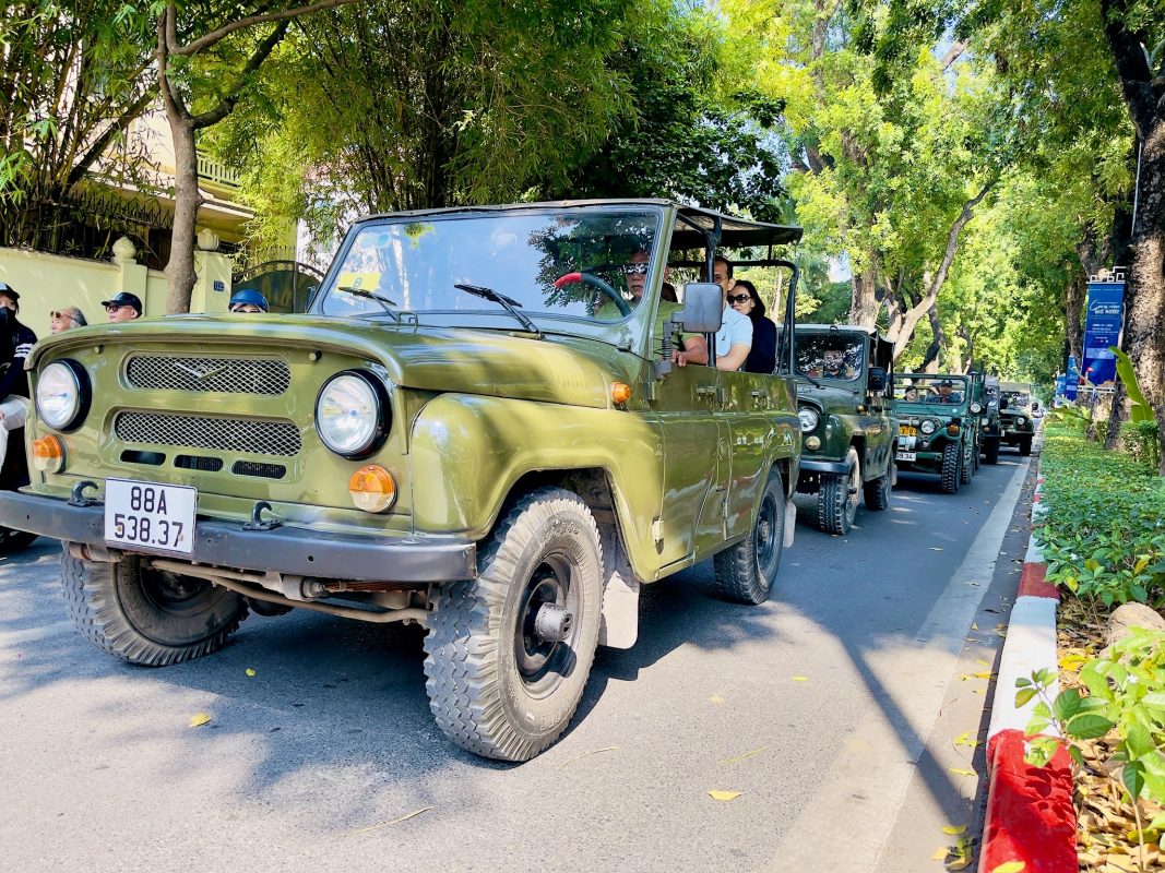Travelers learning local culture on a Hanoi countryside Jeep ride