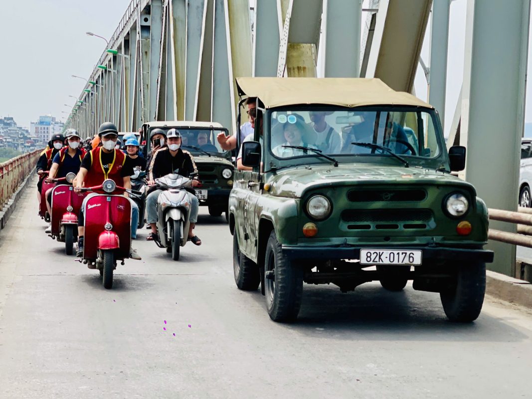Happy tourists on a Hanoi Jeep Tour during sunset