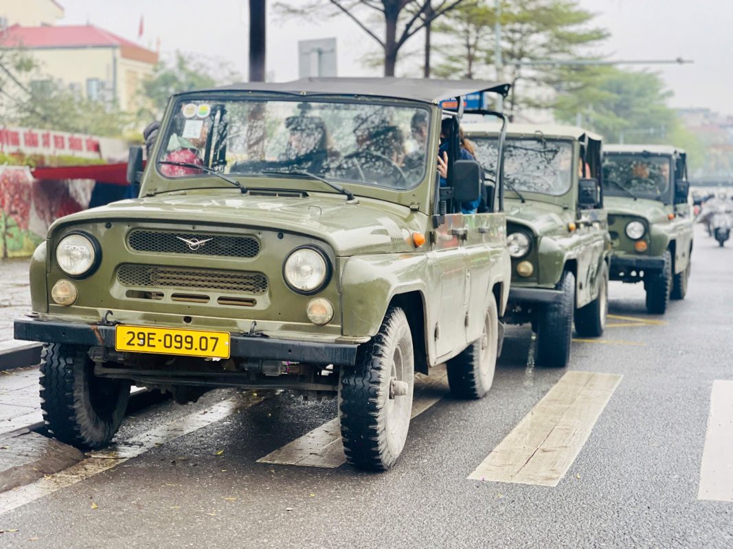 A group enjoying a scenic Hanoi Jeep Tour near the West Lake