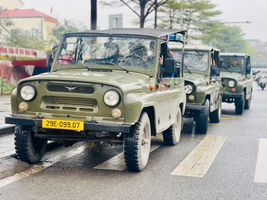 A group enjoying a scenic Hanoi Jeep Tour near the West Lake