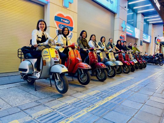 Night Vespa Tour in Hanoi with city lights and street life